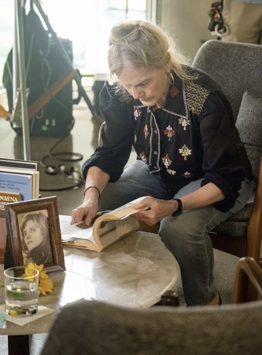 Nancie reading on set