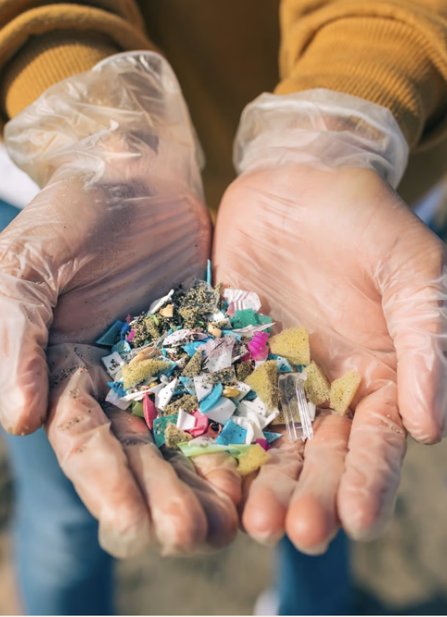 Gloved hands holding collected microplastics
