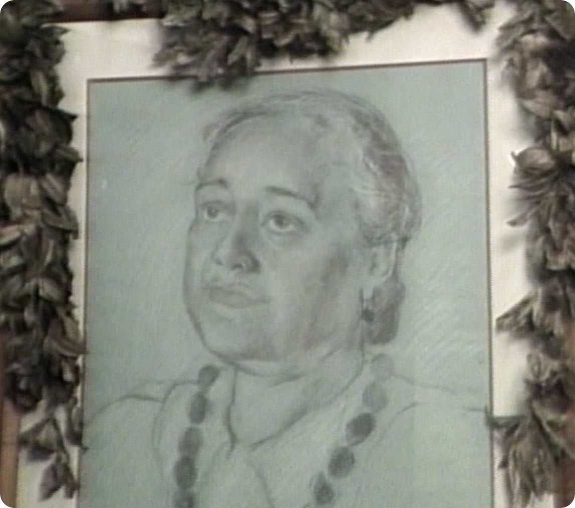 Portrait of Mary Kawena Pukui framed with lei